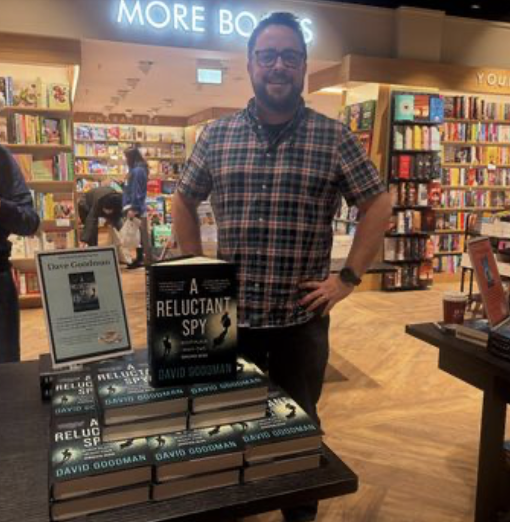 Me at the Braehead event with a pile of my books