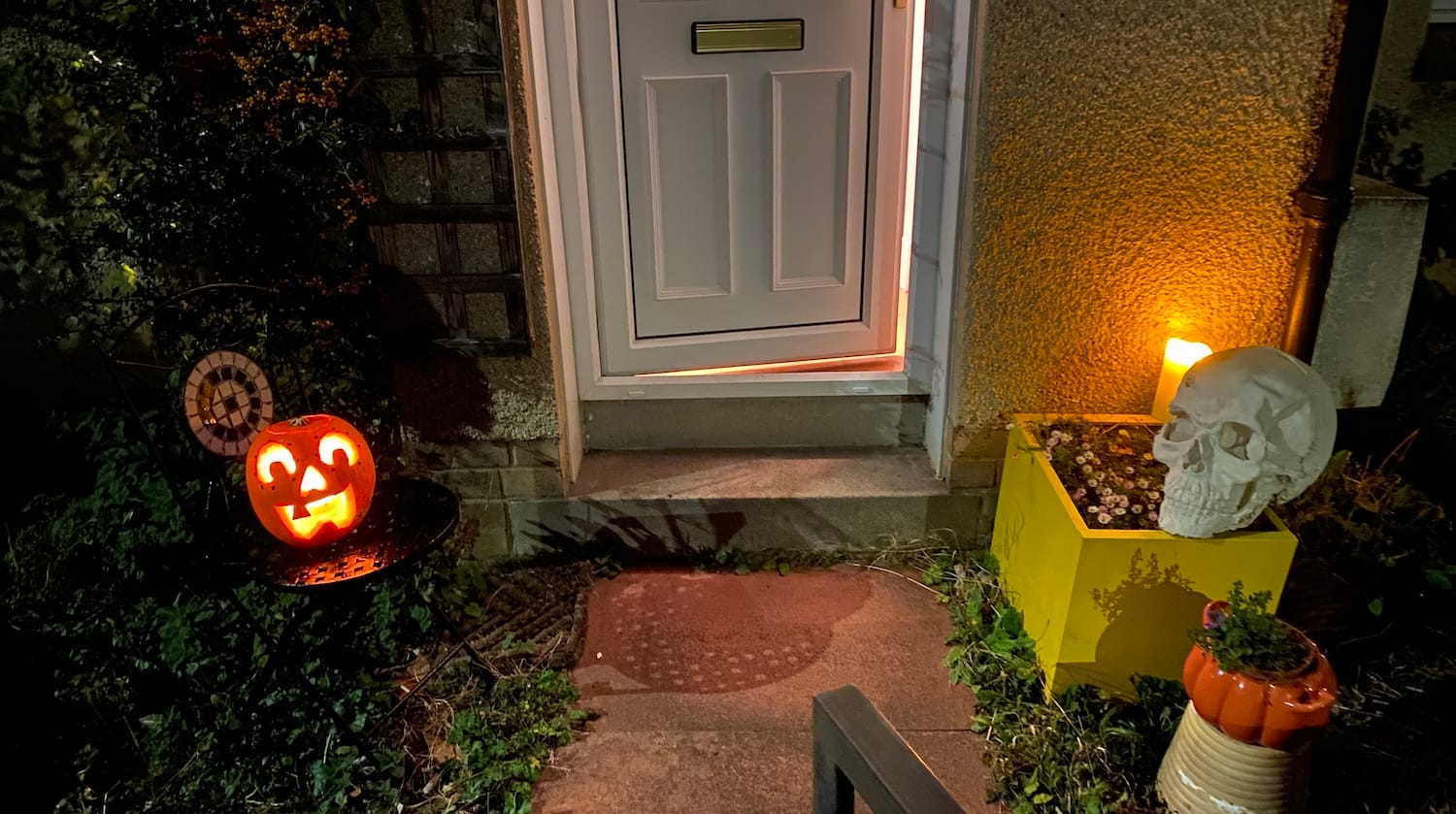 A pumpkin, plaster skull and candles outside my front door