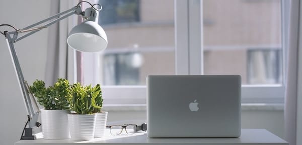 Macbook, anglepoise lamp, glasses, sunny window